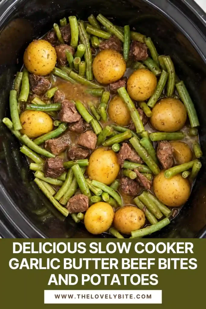 Crockpot beef bites cooked with baby potatoes, minced garlic, butter, and fresh green beans. The finished dish has tender beef and potatoes coated in a rich savory sauce.