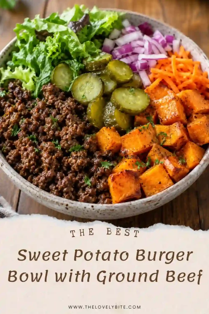 A colorful sweet potato burger bowl topped with juicy ground beef, crisp lettuce, diced tomatoes, sliced red onion, and pickles. The easy dinner recipe highlights warm roasted sweet potatoes and fresh toppings.
