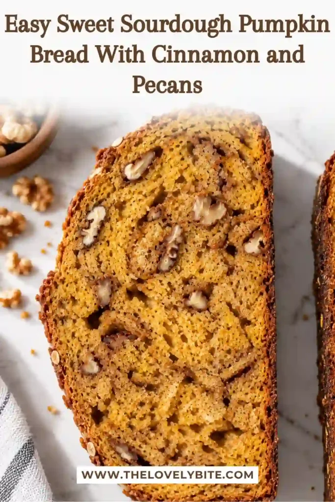 Sliced pumpkin sourdough bread filled with cinnamon, brown sugar, roasted pumpkin, nutmeg, and crunchy pecans. This homemade fall sourdough recipe is baked until deeply golden.