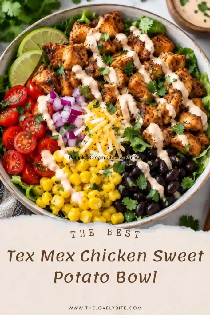 A healthy chicken bowl featuring sliced Tex-Mex chicken, roasted sweet potatoes, black beans, corn, and fresh vegetables. A creamy lime yogurt sauce is drizzled over the colorful ingredients.