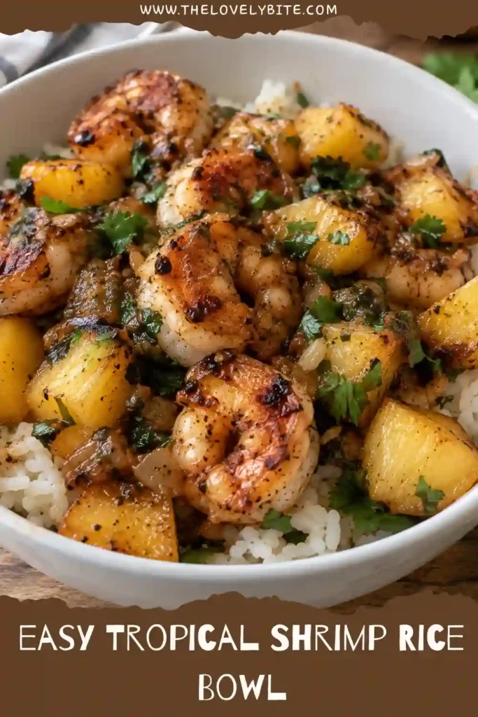 Close-up of a shrimp rice bowl with browned pineapple chunks and tender shrimp over cilantro jasmine rice. The dish is coated in a sweet pineapple, lime, honey, and chili sauce.